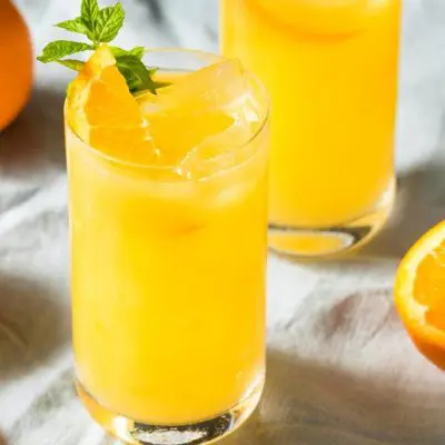 Two Orange Crush Cocktails with orange garnish