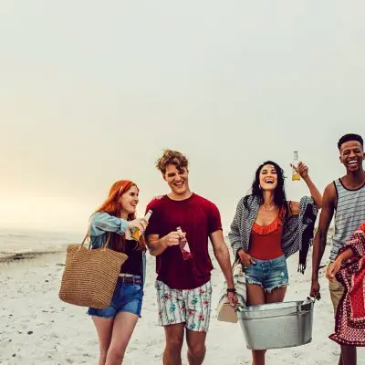 Friends carrying cooler boxes to BYOB Party