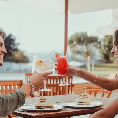 A couple clinking cocktails together on Valentines Day