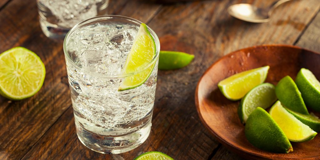 Vodka Soda on the rocks with a lime wedge garnish