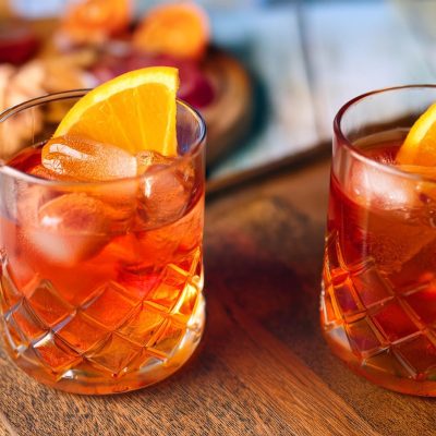 Two Aperol Negroni Cocktails with orange slice garnish
