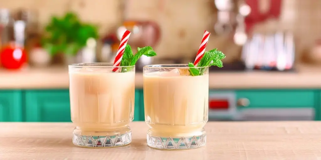 Two Peppermint White Russian mocktails with candy cane and fresh mint garnish