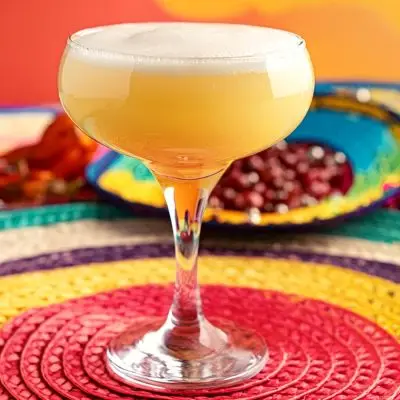 A close-up of a Matador cocktail served in a coupe glass for Cinco de Mayo