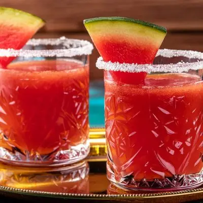 Close up of two Watermelon Daiquiri cocktails with watermelon wedge garnish