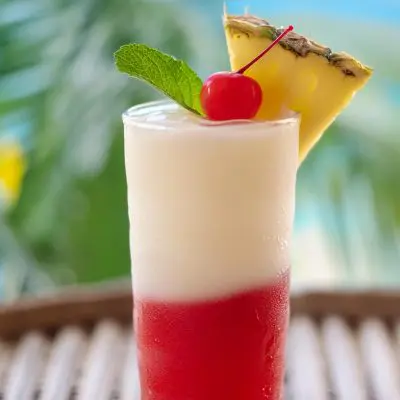 Closeup of a Miami Vice cocktail for a tropical housewarming party theme