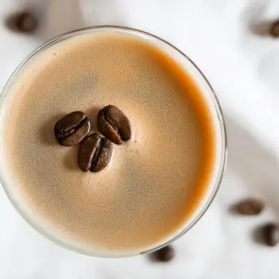 Top view of an Espresso Martini garnished with three coffee beans for good luck