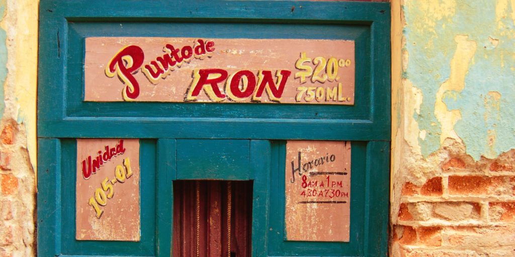 A turquoise door to a traditional rum shop in Cuba