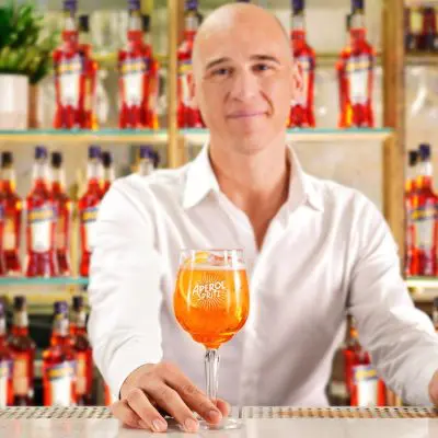 Headshot of Loris Contro holding a glass of Aperol Spritz, Brand Ambassador for Italian Icons, Campari Group UK