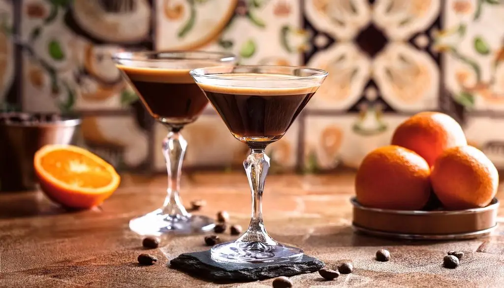 Two Grand Marnier Espresso Martinis in a French-style kitchen, bowl of oranges to the side 