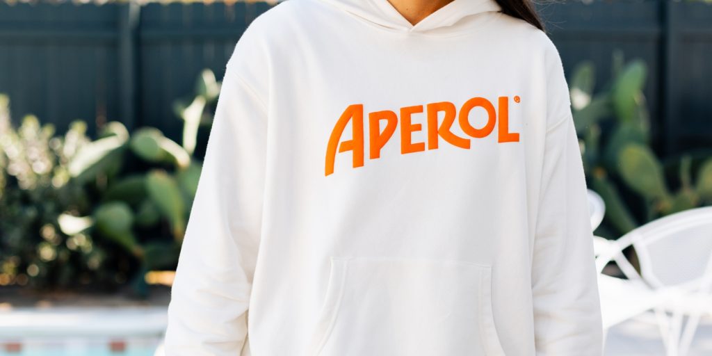 A close-up of a white Aperol hoodie