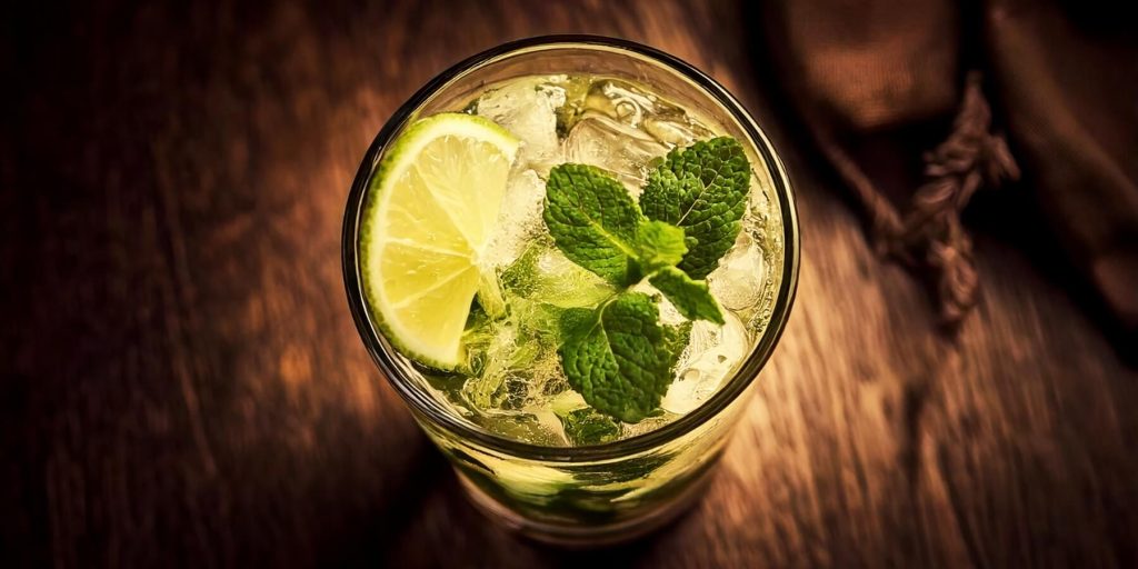 Close-up overhead shot of a Mojito cocktail with fresh lime and mint garnish